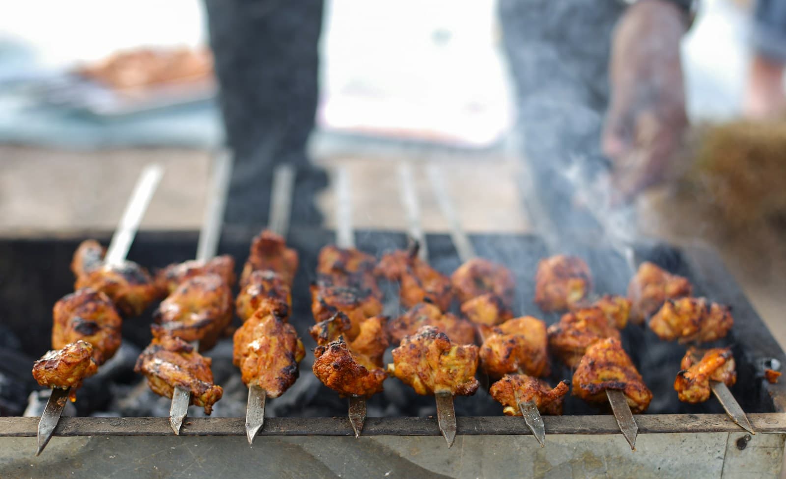 Meat cooking over a charcoal grill