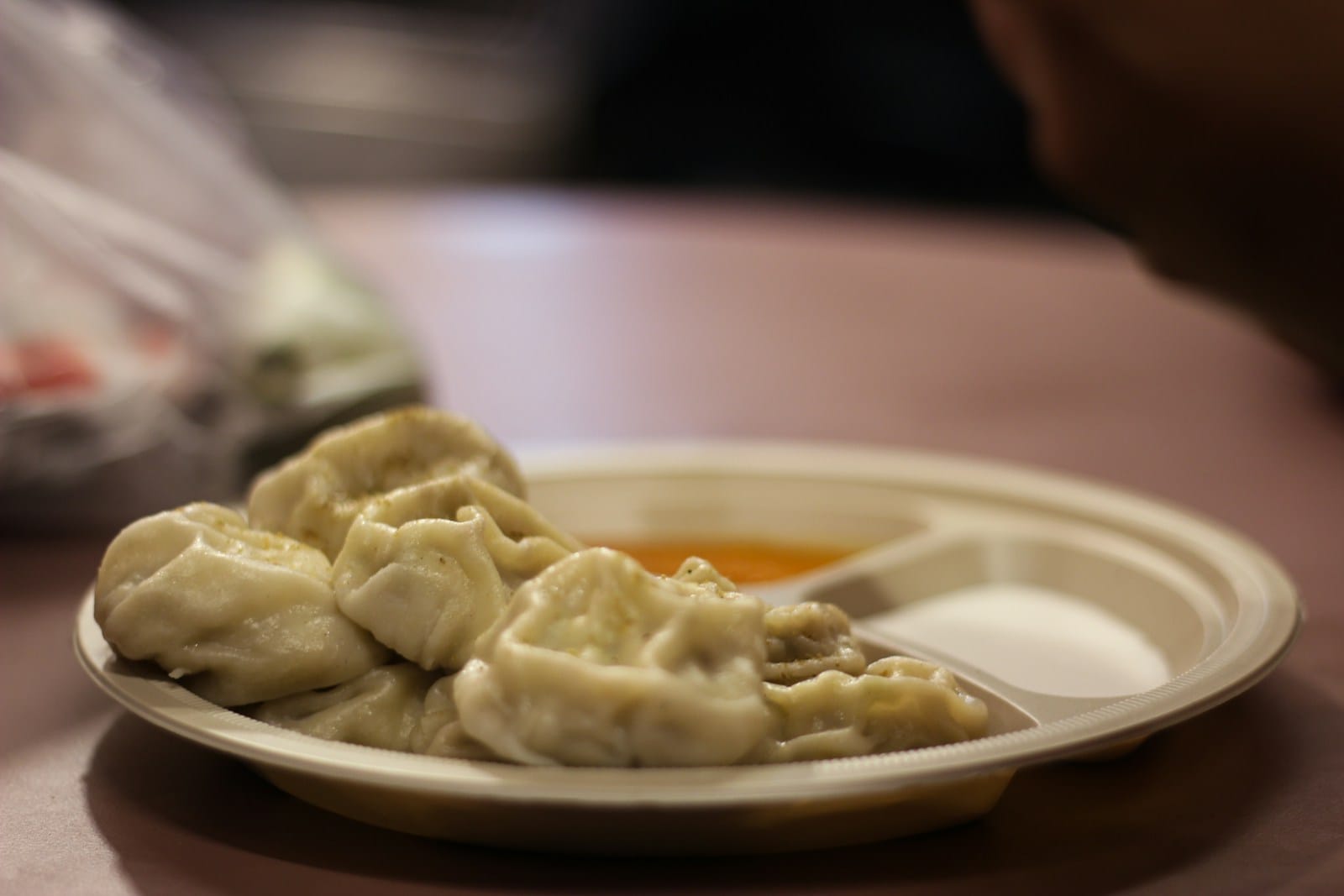 Crisp fried momos served with a dark chilli dipping sauce