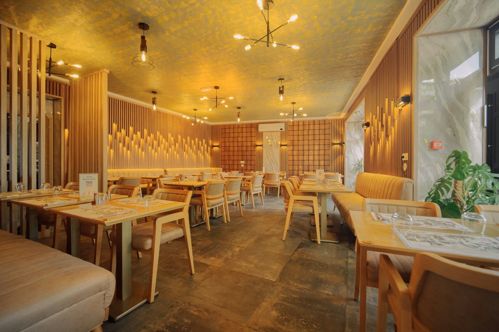 Modern restaurant interior with warm lighting and banquette seating